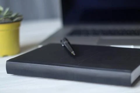 Laptop and documents in the workplace. Stock Photos