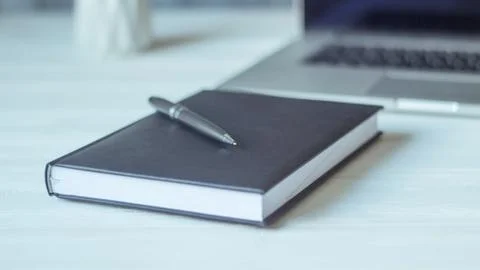 Laptop and documents in the workplace. Stock Photos