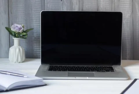 Laptop and documents in the workplace. Stock Photos