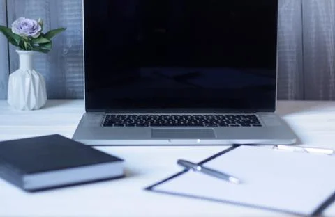 Laptop and documents in the workplace. Stock Photos