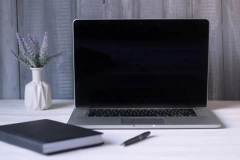 Laptop and documents in the workplace. Stock Photos