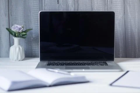 Laptop and documents in the workplace. Stock Photos
