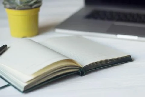 Laptop and documents in the workplace. Stock Photos