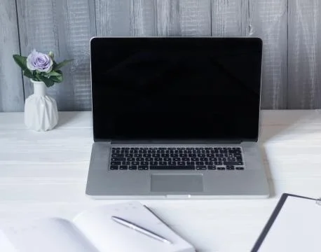 Laptop and documents in the workplace. Stock Photos