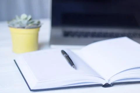 Laptop and documents in the workplace. Stock Photos