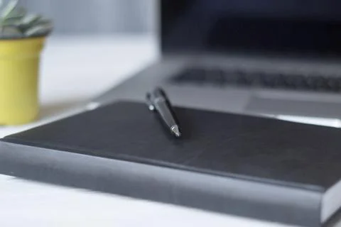 Laptop and documents in the workplace. Stock Photos