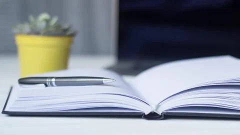 Laptop and documents in the workplace. Stock Photos
