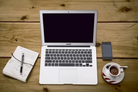 Laptop and electronics keeps on table Stock Photos
