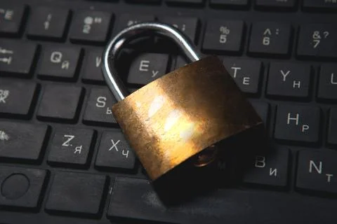 Laptop and lock on table, security concept Stock Photos