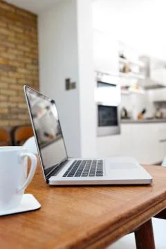 Laptop and mug on table Stock Photos