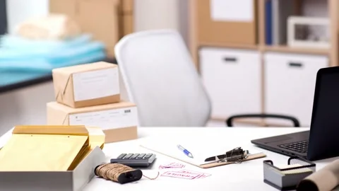 Laptop and parcels on table at post office Stock Footage 130709053