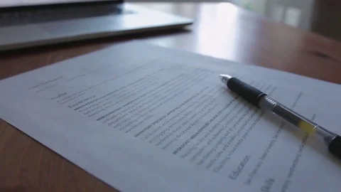 Laptop and Resume on Top of A Table Video stock 82250331