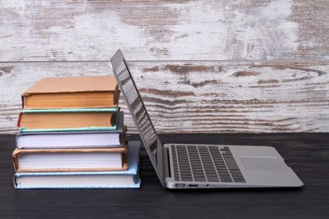 Laptop and stack of books. 스톡 사진