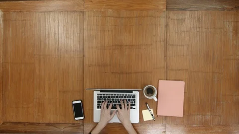 Laptop and typing hands  overhead at desk Stock Footage 101604451