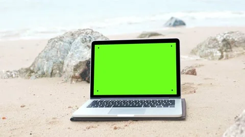 Laptop on the beach, keylight green background Video stock 60407744