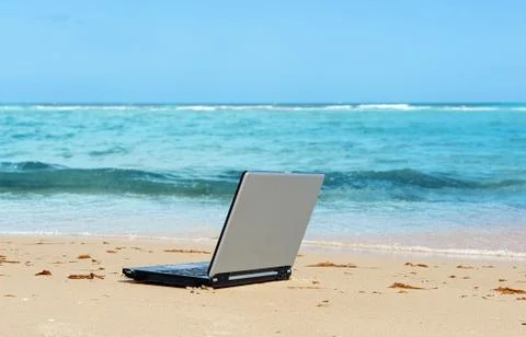 Laptop on the beach Stock Photos