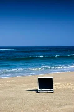 Laptop on the beach Stock Photos