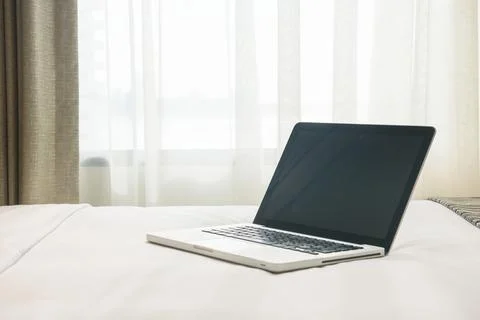 A laptop on a bed Stock Photos