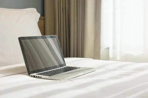 A laptop on a bed Foto stock