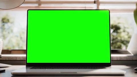Laptop with a blank green screen, featuring zoom and static looped footage .. Stock Footage 273479002