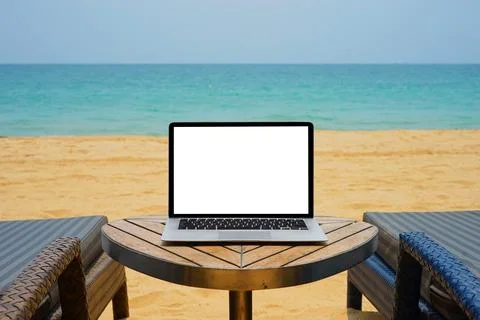 Laptop with blank screen for creative design on the table nearby sea and be.. Stock Photos