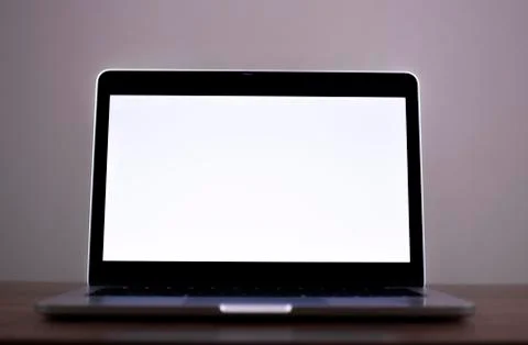 Laptop with blank screen on Empty space white desk,at cafe blurred background of Stock Photos