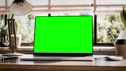 Laptop with a blank screen is placed on a stylish wooden desk within a loft.. Stock Footage 272441187