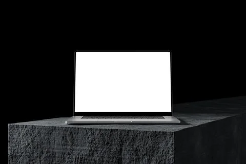 Laptop with a blank screen on a stone table, dark background. A modern scen.. Stock Photos