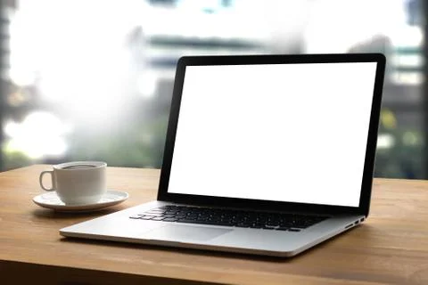 Laptop with blank screen on table interior, man at his workplace using tech.. Foto stock