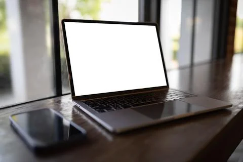 Laptop with blank screen on table. Workspace background new project on lapt.. Stock Photos