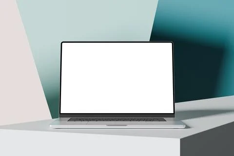 Laptop with a blank screen on a white table, colorful background. A modern .. Stock Photos