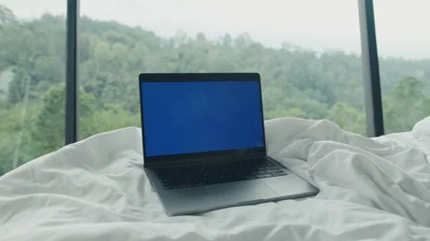Laptop with blue screen on white bed with mountain view Stock Footage 307908703