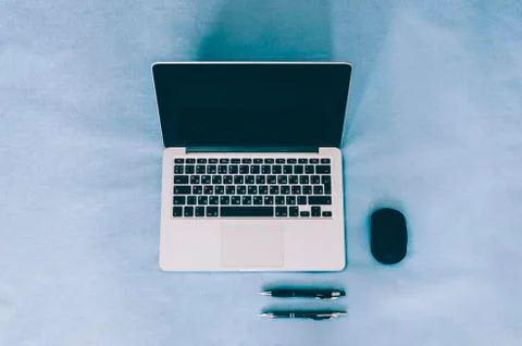 Laptop On Blue Table Stock Photos