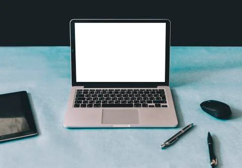 Laptop On Blue Table Stock Photos