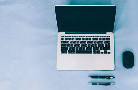 Laptop On Blue Table Stock Photos