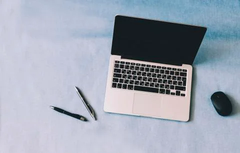 Laptop On Blue Table Stock Photos