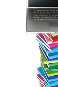 Laptop on book stack, top partial view Stock Photos
