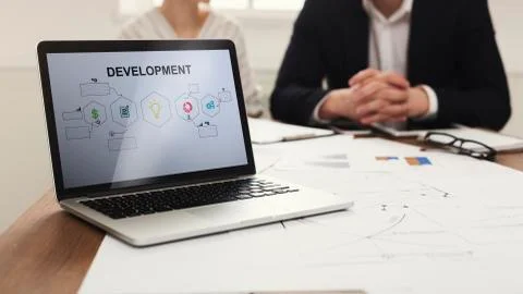 Laptop With Business Development Scheme On Screen In Modern Office Foto stock
