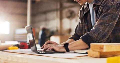 Laptop, carpenter and hands of man in workshop for planning, project quote .. Stock Photos