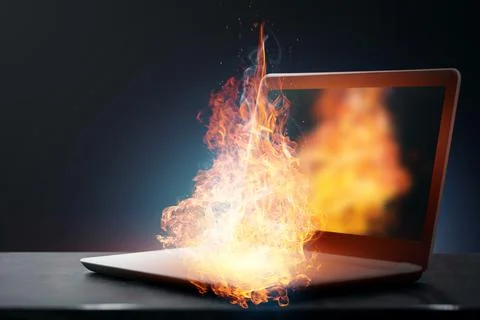 The laptop caught fire during operation, overheated from heavy loads. Stock Photos