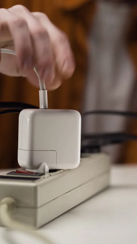 Laptop charger with type-c put on multiple socket. Electrical equipment and Stock Footage 309541936