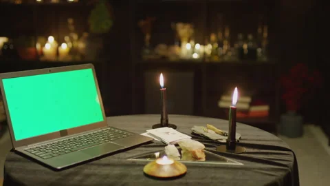 Laptop with Chroma Key Screen on Table with Burning Candles Stock Footage 247635016