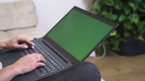 Laptop with chrome key screen stands on the couch Stock Footage 220177041