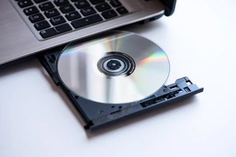 Laptop with compact disc close up shoot Stock Photos
