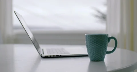 Laptop computer and coffee cup on a desk. Stock Footage 88370215