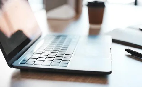 Laptop, computer and desk with a notebook on a table in an empty office at work Stock Photos