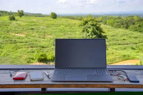 Laptop computer and device for working digital nomad put on table, background Stock Photos