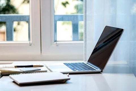 Laptop computer and documents on the table Stock Photos