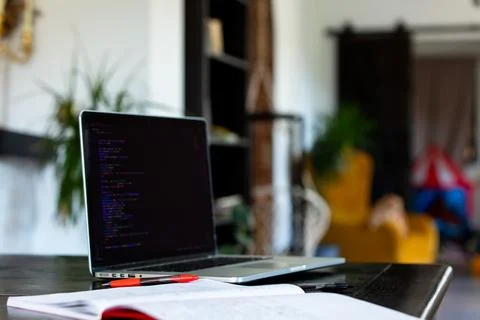 Laptop computer and notebook with pen on a table in home office Foto stock