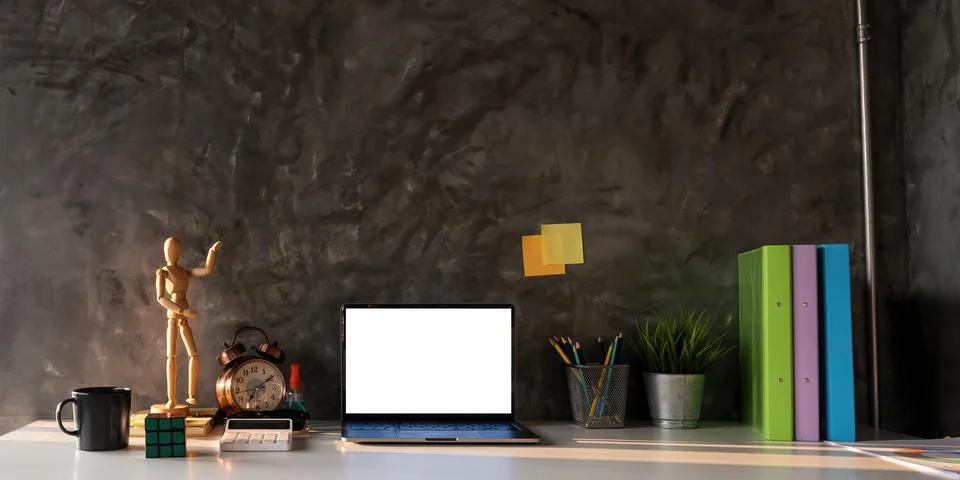 Laptop computer and office tools with blank screen on table with morning light. Stock Photos